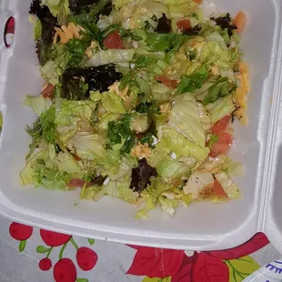 a salad in a styrofoam container