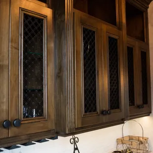 a kitchen with dark wood cabinets