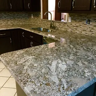 Ganache Granite Countertop with Mosaic Tile Backsplash.