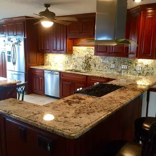 Kitchen Remodel: Ice Brown Granite Countertops with High Backsplash and Cherry Wood Custom Cabinets.