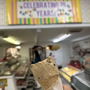 a hand holding an ice cream cone