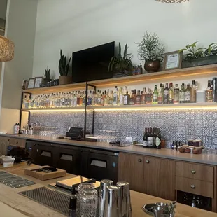 a bar with a lot of bottles on the shelves