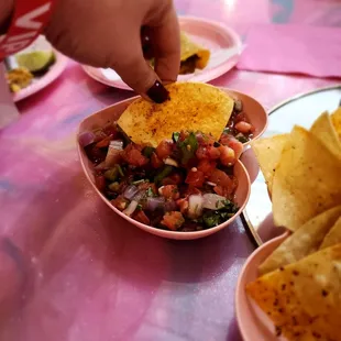 a plate of chips and a bowl of salsa