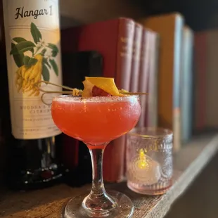 a pink cocktail with a garnish garnish garnish garnish garnish garnish ga