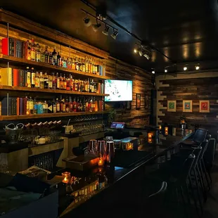 a bar with a lot of bottles on the shelves