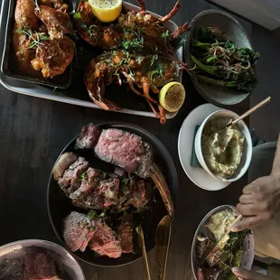 Tomahawk steak and lobster with side of mashed potatoes and broccolini