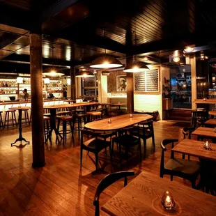 a restaurant with wooden tables and chairs