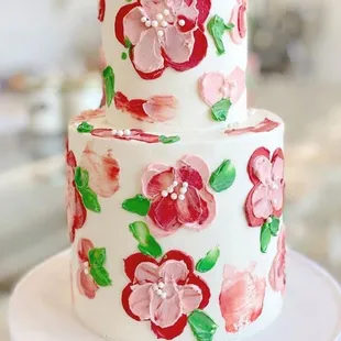 a white cake with pink flowers