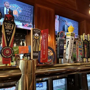 a row of beer taps on a bar