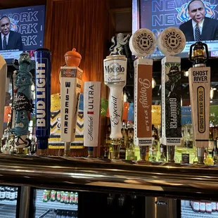 a row of beer taps on a bar