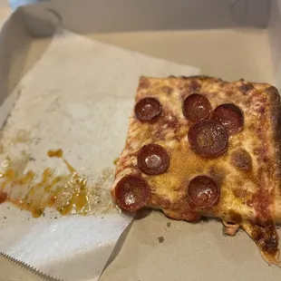 a slice of pizza in a box