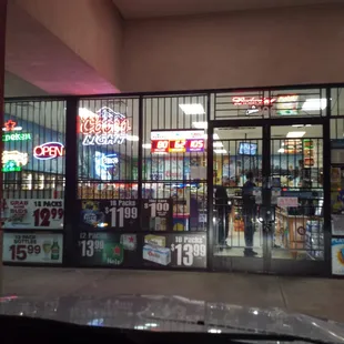 a storefront with neon signs