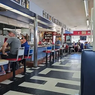 If all the booths are full, try the counter. You might meet somebody interesting.