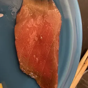 Spoiled blue fin tuna sashimi. (Notice brown edges and general sliminess.)