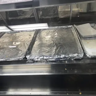 pans of food on a conveyor belt