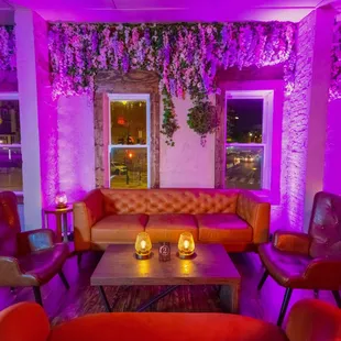 a living room with purple lighting