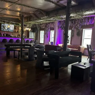 the interior of a restaurant with purple lighting