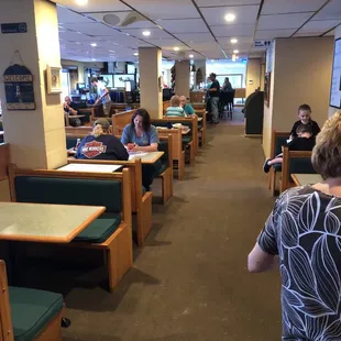 people sitting at tables in a restaurant
