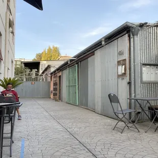 a patio area with tables and chairs