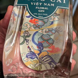 a hand holding a bottle of wine