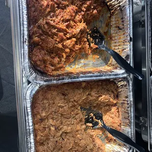 two trays of food being prepared