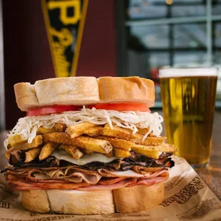 a sandwich with fries and a beer