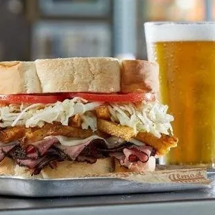 a sandwich and a glass of beer