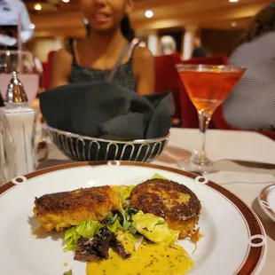 a woman sitting at a table with a plate of food