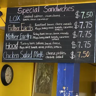 a menu for special sandwiches on a blackboard