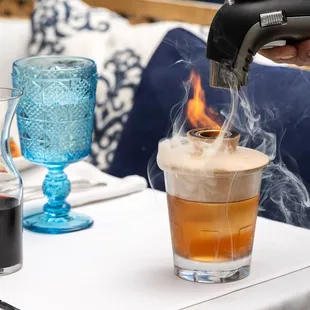 Cherry Oak Smoked Old Fashion smoking at the table