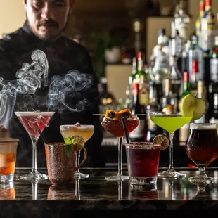 Armando makes several drinks for a party