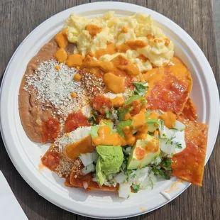 Chilaquiles. Add that hot orange salsa once you get your order!