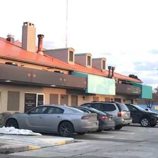 a row of parked cars in front of a restaurant