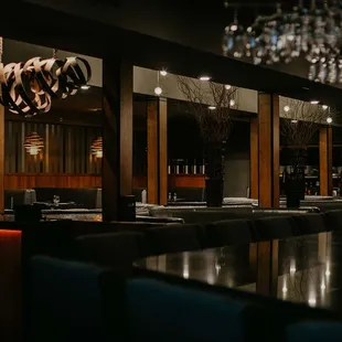 a dining room with a chandelier hanging from the ceiling