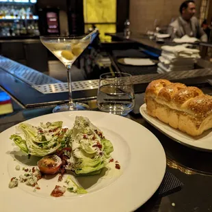 a plate of salad, bread and a glass of wine