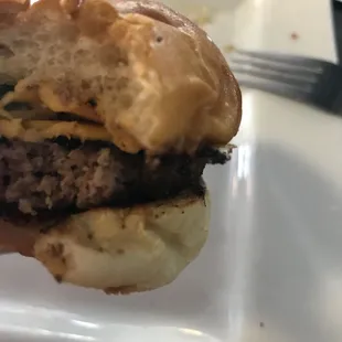 Lunch cheeseburger, burnt and hard to eat