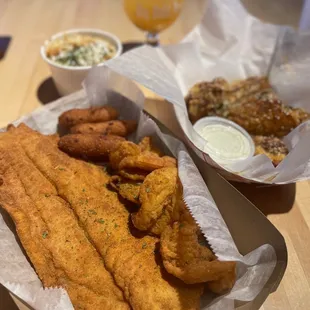 a basket of fried fish and fries