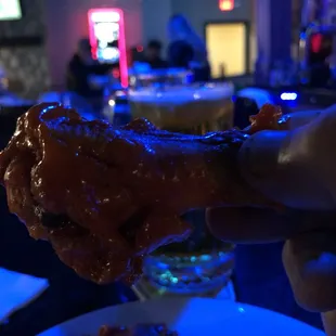 a hand holding a piece of food