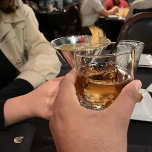 a person holding a glass of alcohol