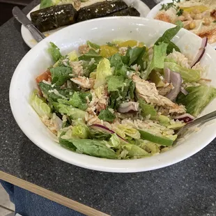 a bowl of salad and a plate of bread