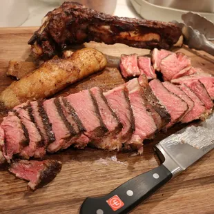 a steak on a cutting board with a knife