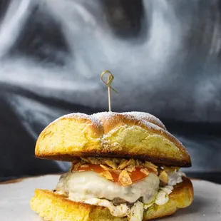 a sandwich on a plate with smoke in the background