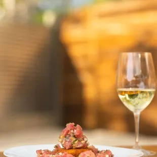 a plate of food and a glass of wine