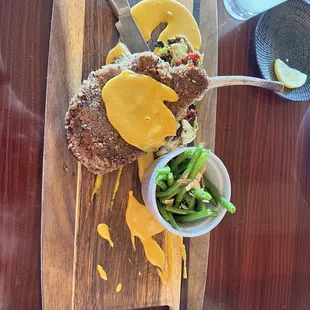 Pecan encrusted pork loin with pumpkin sauce atop Brussels sprout hash, with a side of green beans with almonds.