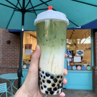 Matcha boba drink in a cute cup.