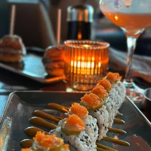 Lobster roll sushi in the foreground with prime sliders in the back.