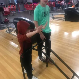 a boy and a girl playing bowling