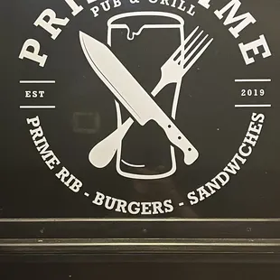 The sign behind my wife&apos;s head in our booth.