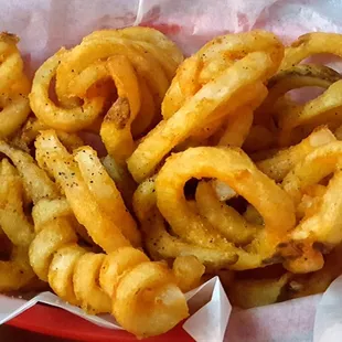 Basket of curly fries, heavy with black pepper -- as requested
