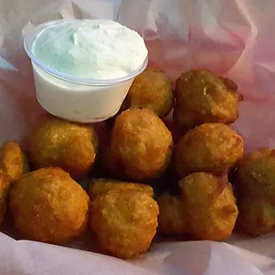 Deep-fried mushrooms with creamy horseradish dipping sauce for an appetizer